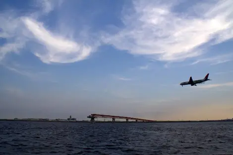 View of a landing airplane from Jonanjima Seaside Park